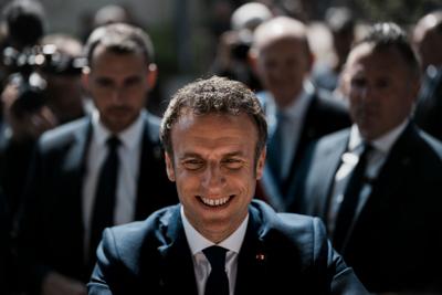 French President  Emmanuel Macron greets well-wishers after casting his vote in Le Touquet, northern France, on April 24, 2022.