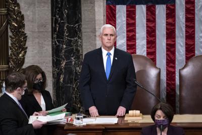 Vice President Mike Pence returns to the House chamber after midnight, Jan. 7, 2021.