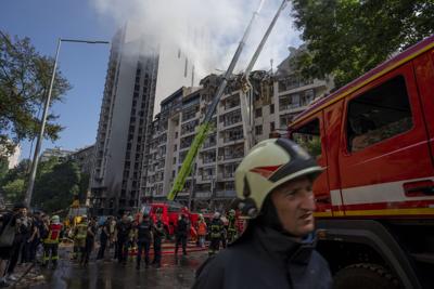 Firefighters work at the scene of a residential building following explosions, in Kyiv, Ukraine, Sunday, June 26, 2022.