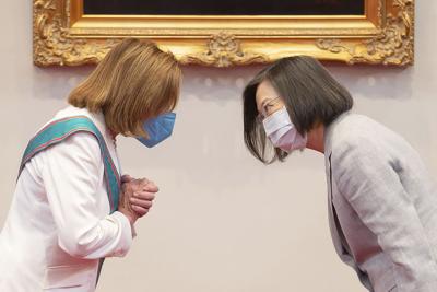 In this photo released by the Taiwan Presidential Office, U.S. House Speaker Nancy Pelosi, left, and Taiwanese President Tsai Ing-wen gesture during a meeting in Taipei, Taiwan.