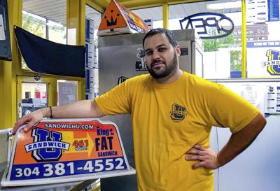 This April 2017, file photo photo shows George Tanios at his sandwich shop in Morgantown, W.Va.