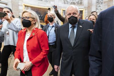 Former Vice President Dick Cheney walks with his daughter Rep. Liz Cheney (R-Wyo.) in the Capitol Rotunda at the Capitol in Washington, Jan. 6, 2022.