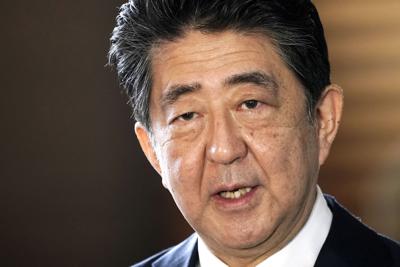 Japan's outgoing Prime Minister Shinzo Abe speaks to the media as he arrives at the prime minister's office for a cabinet meeting in Tokyo on Sept. 16, 2020. Japan’s NHK TV said on Friday that former Prime Minister Abe apparently was shot at and collaps...