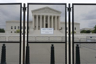 An anti-scaling fence surrounds the U.S. Supreme Court Thursday, May 5 in Washington.