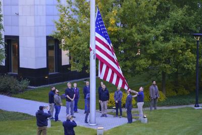 Employees of U.S. embassy in Ukraine raise the U.S. national flag at the U.S. embassy, as Russia's attack on Ukraine continues, in Kyiv, Ukraine, Wednesday, May 18, 2022.
