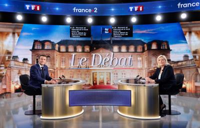 Emmanuel Macron and Marine Le Pen pose before a televised debate in La Plaine-Saint-Denis, outside Paris, on April 20, 2022.
