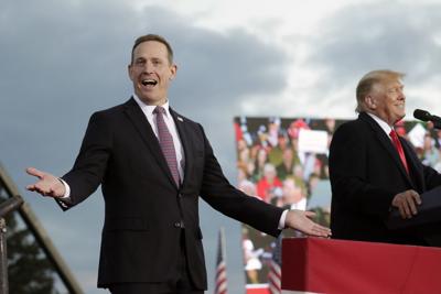 Republican candidate for U.S. Senate Rep. Ted Budd (N.C.), left, reacts as he takes the stage with former President Donald Trump, who endorsed him, during a rally Saturday, April 9, 2022, in Selma, N.C.