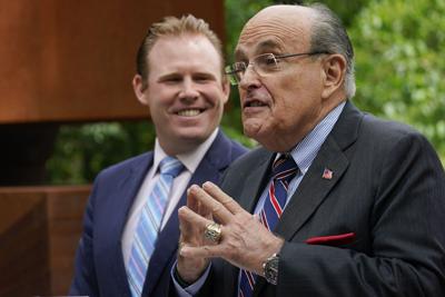 Andrew Giuliani, a Republican candidate for Governor of New York, left, is joined by his father former New York City mayor Rudy Giuliani during a news conference, Tuesday, June 7, 2022, in New York.