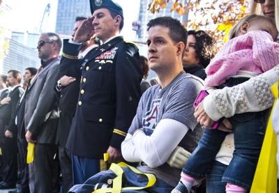 Brian Kolfage, second from right, attends the National September 11 Memorial and Museum's "Salute to Service" tribute honoring U.S. veterans, Nov. 10, 2014 in New York.