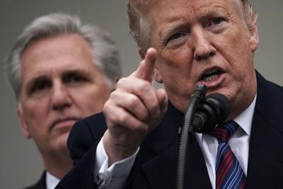 Then-President Donald Trump, right, speaks as Kevin McCarthy, left, listens in the Rose Garden of the White House on Jan. 4, 2019
