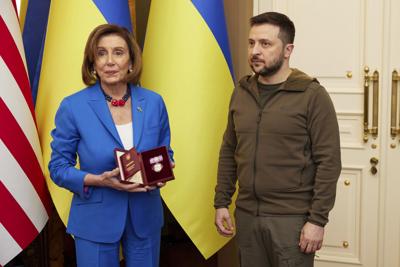 Ukrainian President Volodymyr Zelenskyy presents an award to Speaker of the House Nancy Pelosi in Kyiv on April 30, 2022.