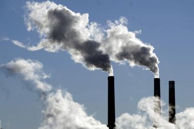 Steam is emitted from smoke stacks at a coal-fired power plant Nov. 17, 2021, in Craig, Colo.