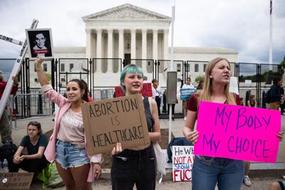 People protest outside the Supreme Court in reaction to news that the court may be poised to overturn Roe v. Wade on May 5, 2022.