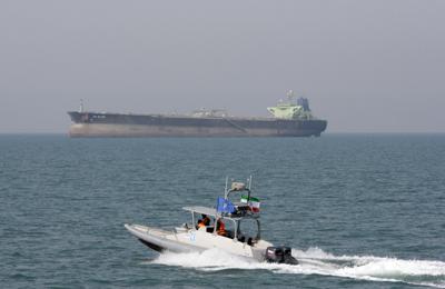 An Islamic Revolutionary Guard Corps speedboat moves in the Persian Gulf near an oil tanker, July 2, 2012.
