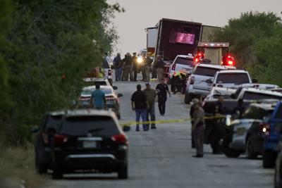 Police and other first responders work the scene where officials say dozens of people have been found dead and multiple others were taken to hospitals with heat-related illnesses after a semitrailer containing suspected migrants was found, Monday, June ...