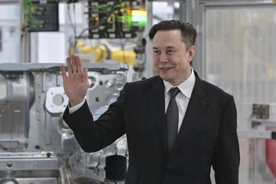 Tesla CEO Elon Musk attends the opening of a Tesla factory.