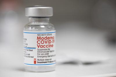 A vial of the Moderna Covid-19 vaccine is displayed on a counter at a pharmacy in Portland, Oregon on Dec. 27, 2021.