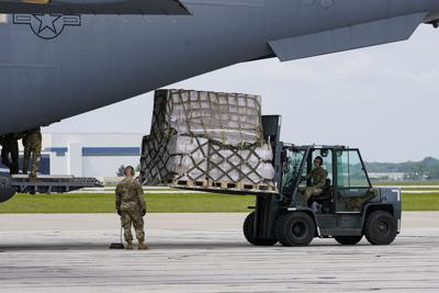 Crew members of an Air Force C-17 unload a plane load of baby formula at the Indianapolis International Airport on May 22, 2022. The 132 pallets of formula arrived from Ramstein Air Base in Germany.