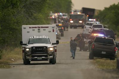 An ambulance leaves the scene where police said dozens of people were found dead in a semitrailer in a remote area in southwestern San Antonio, Monday, June 27, 2022.