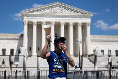 Aaron Petykowski, an activist with the Climate Action Campaign, protests outside the Supreme Court after the court announced its decision in West Virginia v. EPA on Thursday.