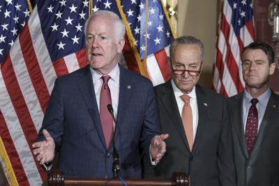 Sen. John Cornyn (R-Texas) joined at right by Senate Majority Leader Chuck Schumer and Sen. Todd Young (R-Ind.), speaks. after passage of a bill at the Capitol in Washington, July 27, 2022.