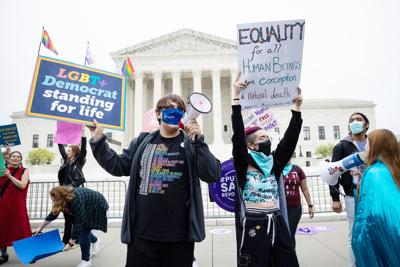 People demonstrate outside the Supreme Court on May 3, 2022, in reaction to news that the court may be poised to overturn Roe v. Wade.