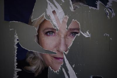 A defaced poster of French presidential candidate Marine Le Pen is seen in Marseille, France, on April 13, 2022.