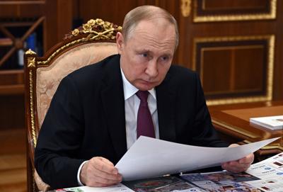 Russian President Vladimir Putin listens to the governor of Yamalo-Nenets Autonomous Area Dmitry Artukhov during their meeting in Moscow, Russia, on March 21, 2022.
