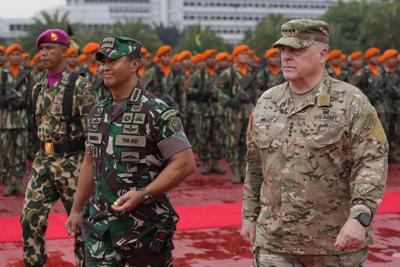 Gen. Mark Milley walks with Indonesian  Gen. Andika Perkasa at Indonesian military headquarters in Jakarta on July 24, 2022.