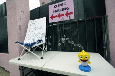 A bubble making device sits adjacent to "this clinic open," sign at the Jackson Women's Health Organization clinic in Jackson, Miss., on July 1, 2022. The clinic is the only facility that performs abortions in the state.