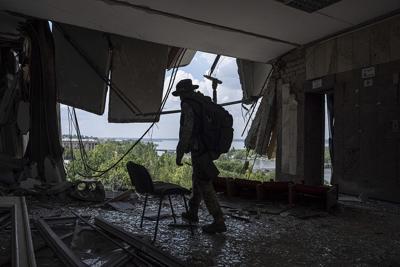 A Ukrainian service member walks inside of the headquarters of the Mykolaiv Regional Military Administration building destroyed by a Russian attack in Mykolaiv, Ukraine, on Aug. 5, 2022.