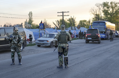 Russian Army soldiers and Donetsk “People's Republic” troops under their command guard a filtration camp in Bezimenne, eastern Ukraine.