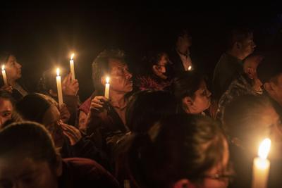 Relatives and friends hold up candles as the bodies of Jair Valencia, Misael Olivares, and Yovani Valencia arrive to their family house in San Marcos Atexquilapan, Veracruz state, Mexico.