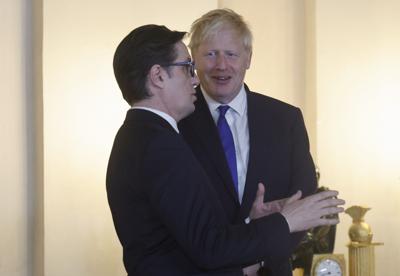 President Stevo Pendarovski of North Macedonia talks with British Prime Minister Boris Johnson before a gala dinner at the Royal Palace in Madrid on June 28, 2022.