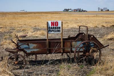 A sign opposing proposed carbon-capture pipelines is seen on a manure spreader on a farm in Iowa Falls, Iowa, April 26, 2022.
