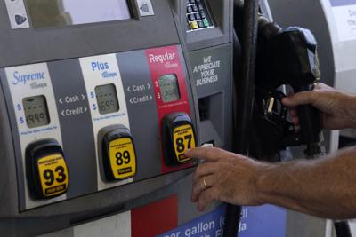 A customer pumps gas at an Exxon gas station on May 10, 2022, in Miami, Fla.