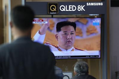 People watch a TV screen showing  North Korea's military parade with an image of  leader Kim Jong Un   in Seoul, South Korea, on April 26, 2022.