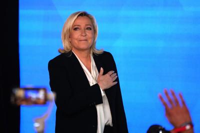 Far-right leader Marine Le Pen gestures as she arrives to speak after the early result projections of the French presidential election runoff were announced in Paris, Sunday, April 24, 2022. French polling agencies are projecting that centrist incumbent...