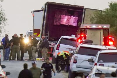 Police and other first responders work the scene where officials say dozens of people have been found dead and multiple others were taken to hospitals with heat-related illnesses after a semitrailer containing suspected migrants was found, Monday, June ...