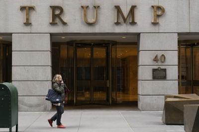 A woman walks past the Trump Building in New York's financial district on Jan. 13, 2021.