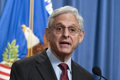 Attorney General Merrick Garland said one of the charges alleges that three of the police officers knew that the affidavit used to obtain the warrant contained false information.