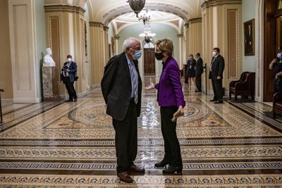 Sens. Bernie Sanders (I-Vt.) and Elizabeth Warren (D-Mass.) speak at the U.S. Capitol on April 28, 2021.