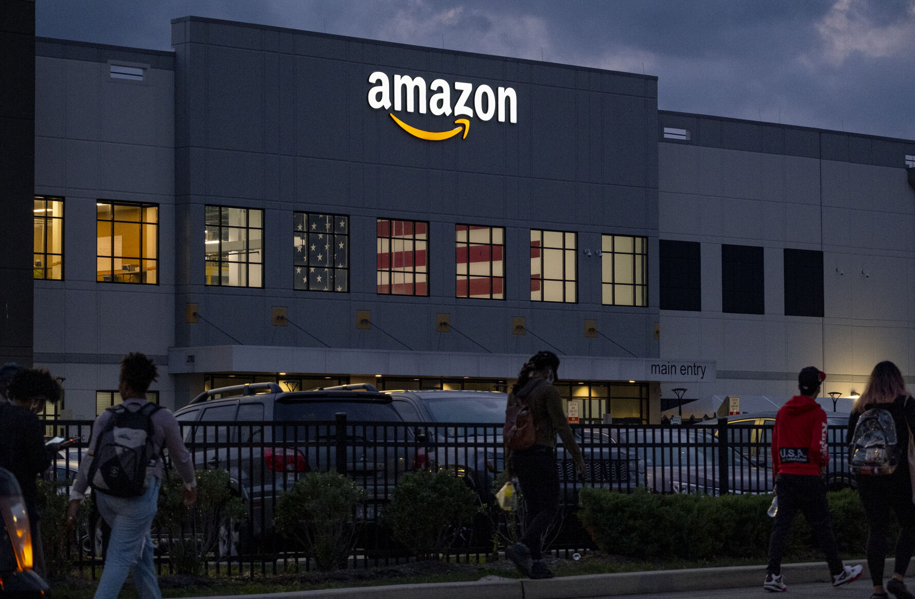 People arrive for work at the Amazon distribution center in the Staten Island borough of New York, Monday, Oct. 25, 2021.