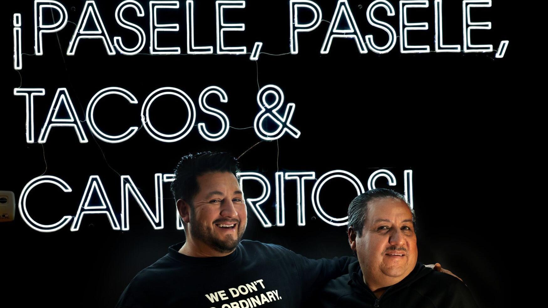 Partners Angel Jimenez-Gutierrez and Alex Ayala stand in front of their sign at the counter of Mestiza.
