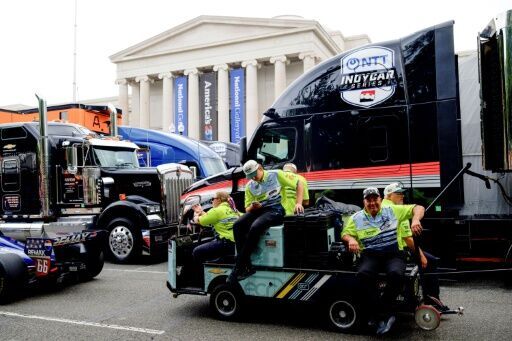 Race team staff prepare to load vehicles into the pit lane area in front of the National Gallery of Art for the Freedom 250 Grand Prix auto race in Washington
