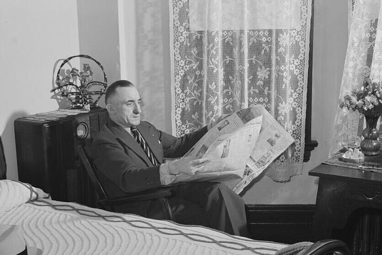 Reading a Butte newspaper 1943
