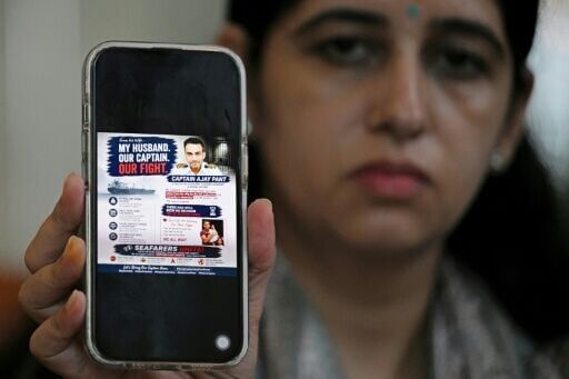 Ritu Pant, the wife of Indian merchant navy captain Ajay Pant, holds a picture of her husband who remains in custody in Britain over sanctions-related offences linked to an alleged Russian 'shadow fleet' oil tanker