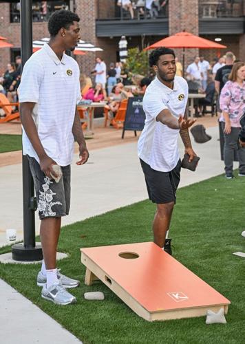 Mizzou basketball players Toni Bryant, left, and Jordan Crawford play cornhole
