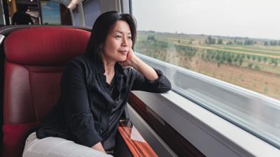 asian female traveler on train
