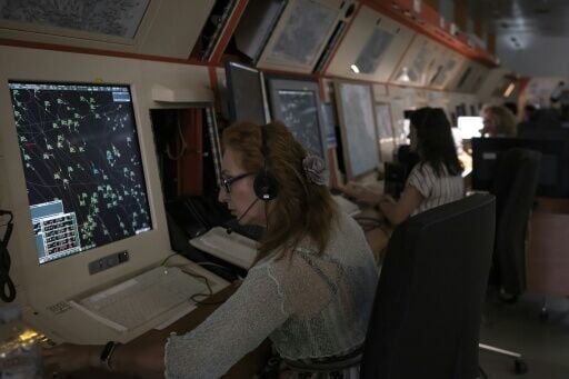 An air traffic controller handles a full radar screen at the Greek Civil Aviation Authority in Athens